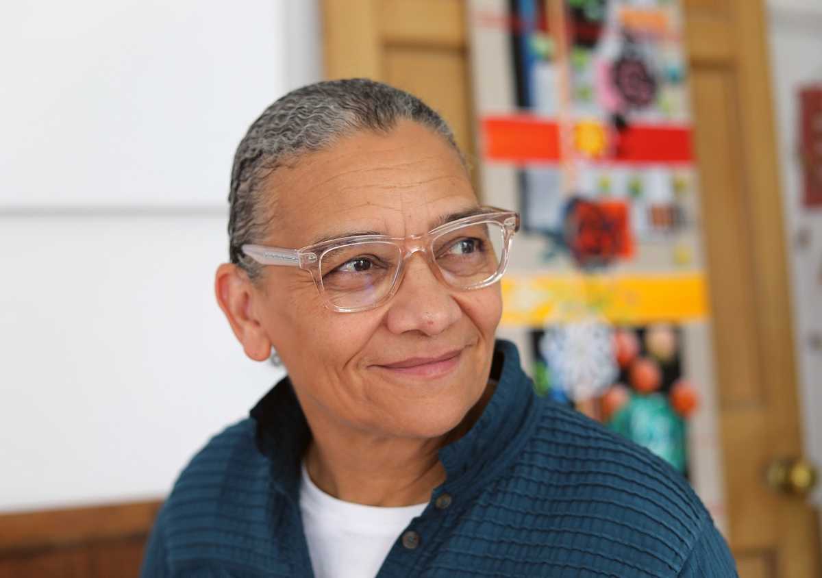 Portrait of Lubaina Himid smiling and looking off to the side.