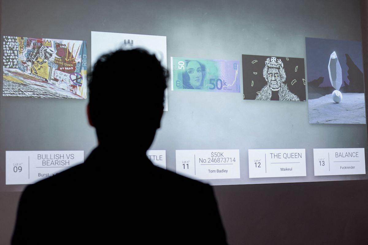 A visitor looks at an 'NFT digital artwork' which will be auctionned on May 20 at the Millon Belgique auction house, in Brussels on May 18, 2021. After the memorable sale by Christie's for $69 million in March of a collage of 5,000 digital images stamped by the American artist Beeple, the Europeans are getting into the NFT act, which is very speculative, as it is directly linked to the cryptocurrency market. (Photo by Kenzo TRIBOUILLARD / AFP) / RESTRICTED TO EDITORIAL USE - MANDATORY MENTION OF THE ARTIST UPON PUBLICATION - TO ILLUSTRATE THE EVENT AS SPECIFIED IN THE CAPTION (Photo by KENZO TRIBOUILLARD/AFP via Getty Images)